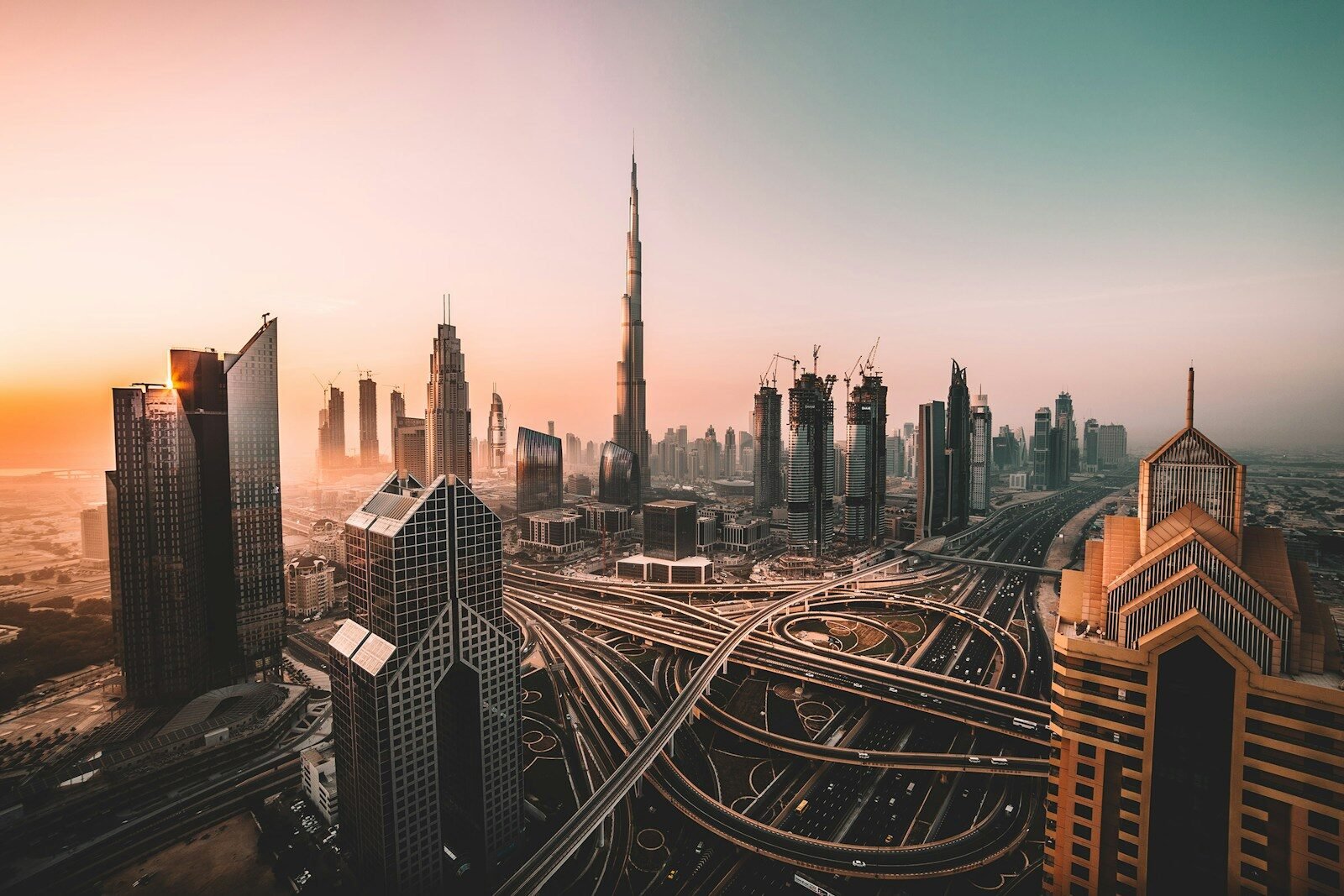 The Burj Khalifa and skyscrapers above a multi-level highway interchange in Dubai