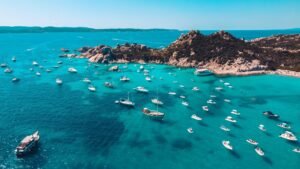 a group of boats floating on top of a body of water