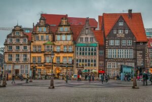a group of people walking around a city square